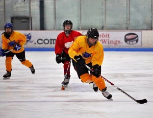 Junior Emma Zeumer handles the puck in a hockey game.Photo reprinted with permission from Emma Zeumer