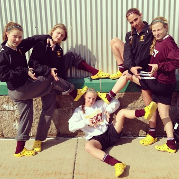 Mercy Varisty Soccer sports their crocs before a game.  Photo Credit: Mia Perelli