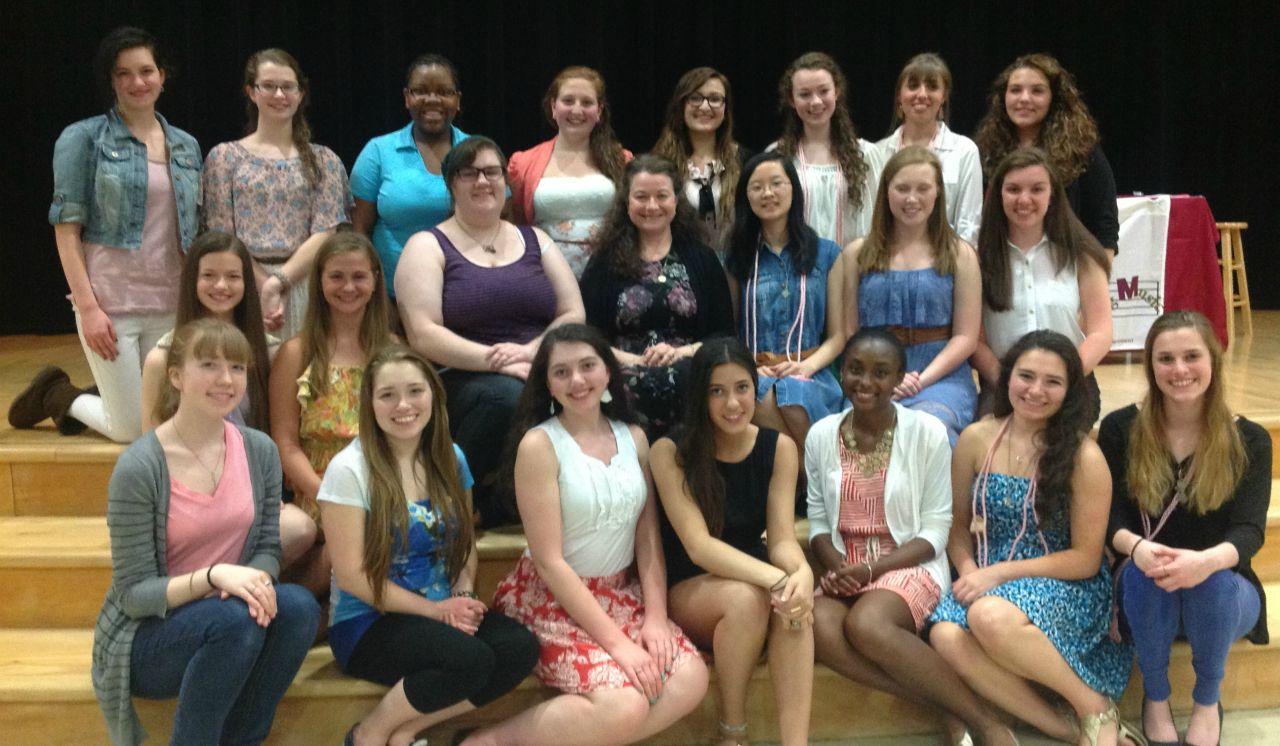 Mrs. Malaney, center, poses with the members of the Tri-M Music Honor Society, of which she is the moderator. Photo reprinted with permission from Amy Malaney.