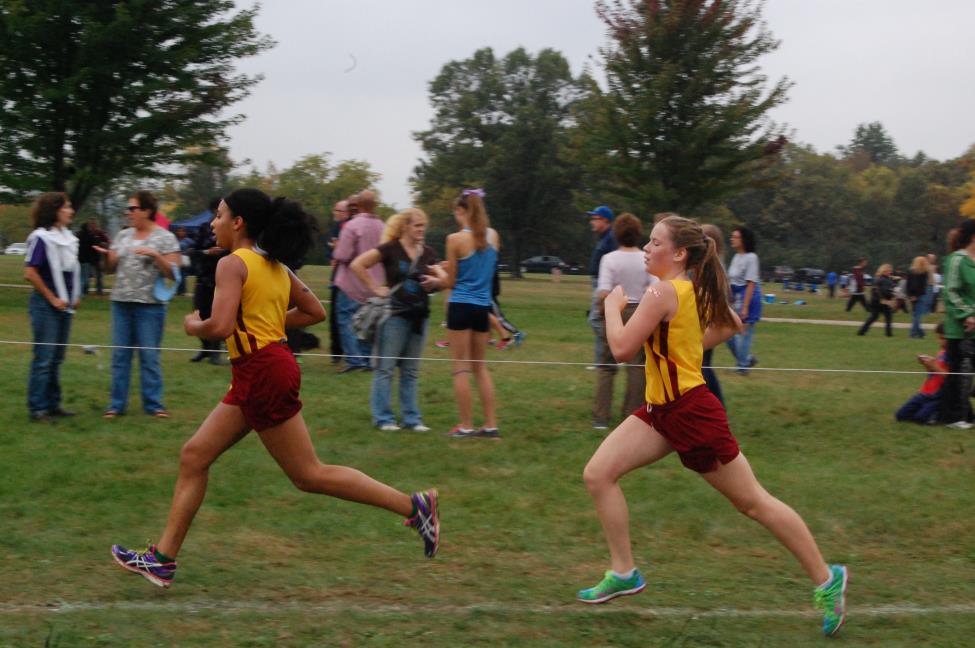 Sophomore Zora Pullen and freshman Gloria Neumann sprint to the finish of the Oakland Country Junior Varsity race.