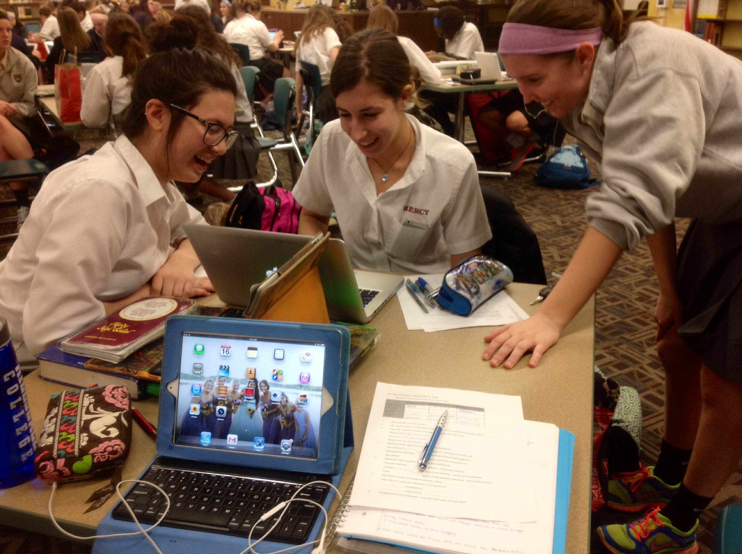 With the weight of finals over with and little to stress over, seniors Monica Niehaus, Lana Grasser and Alysa Graf laugh while viewing a funny video in the library. 