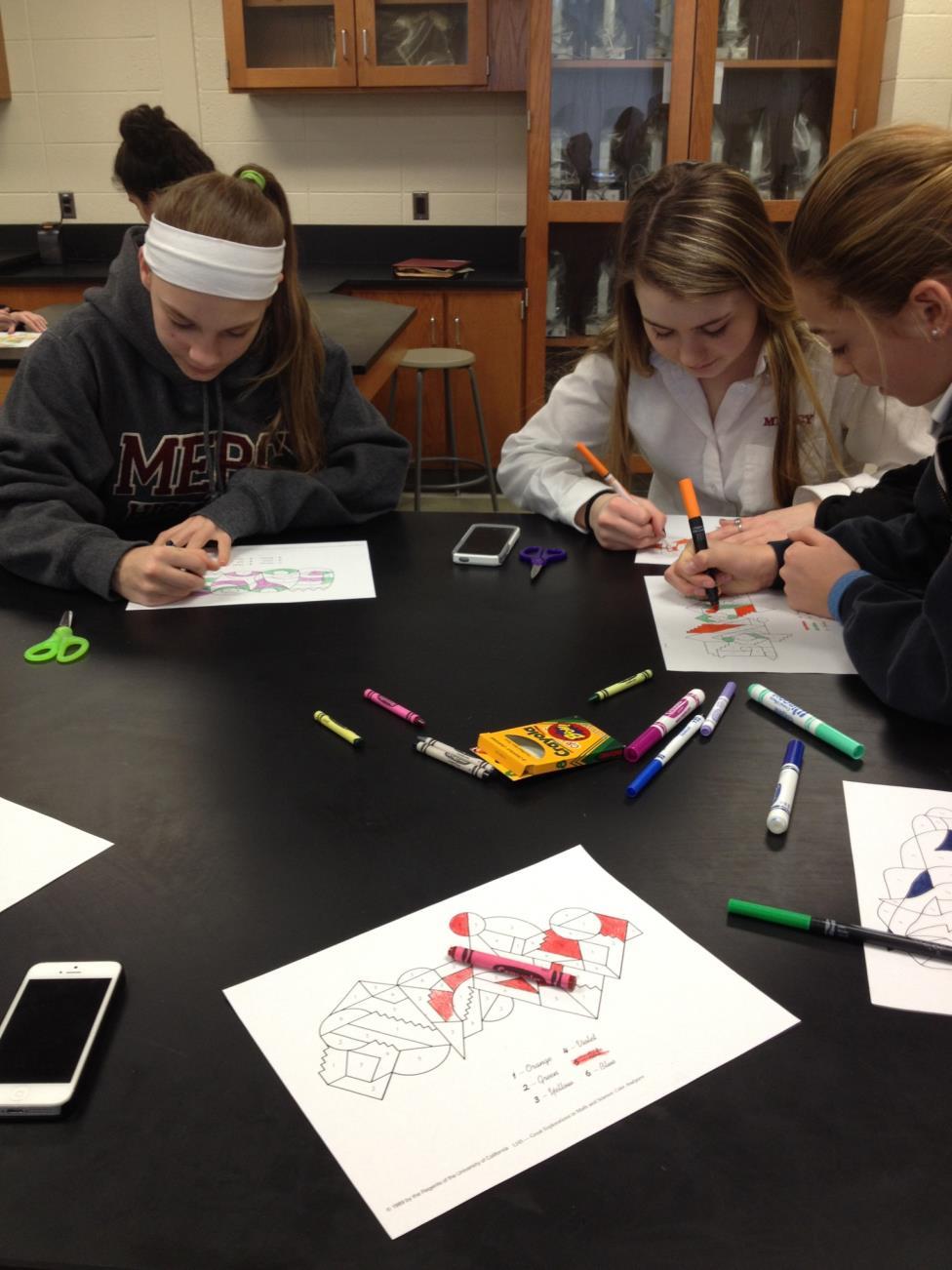 Students color drawings with markers at the most recent Science Club meeting.  Photo Credit: Hannah Hembree